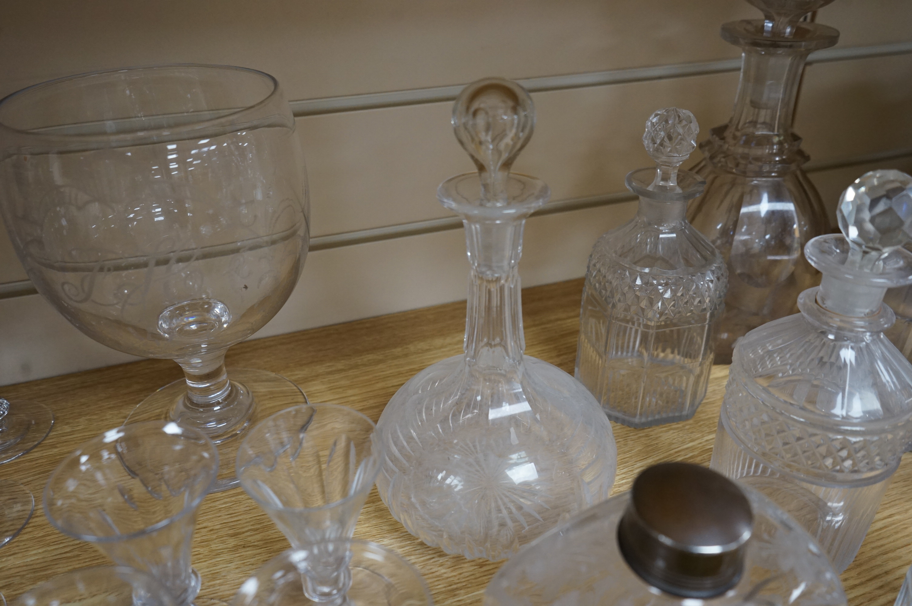 A collection of assorted drinking glassware including sets of decanters and a large etched glass goblet, largest 27cm high